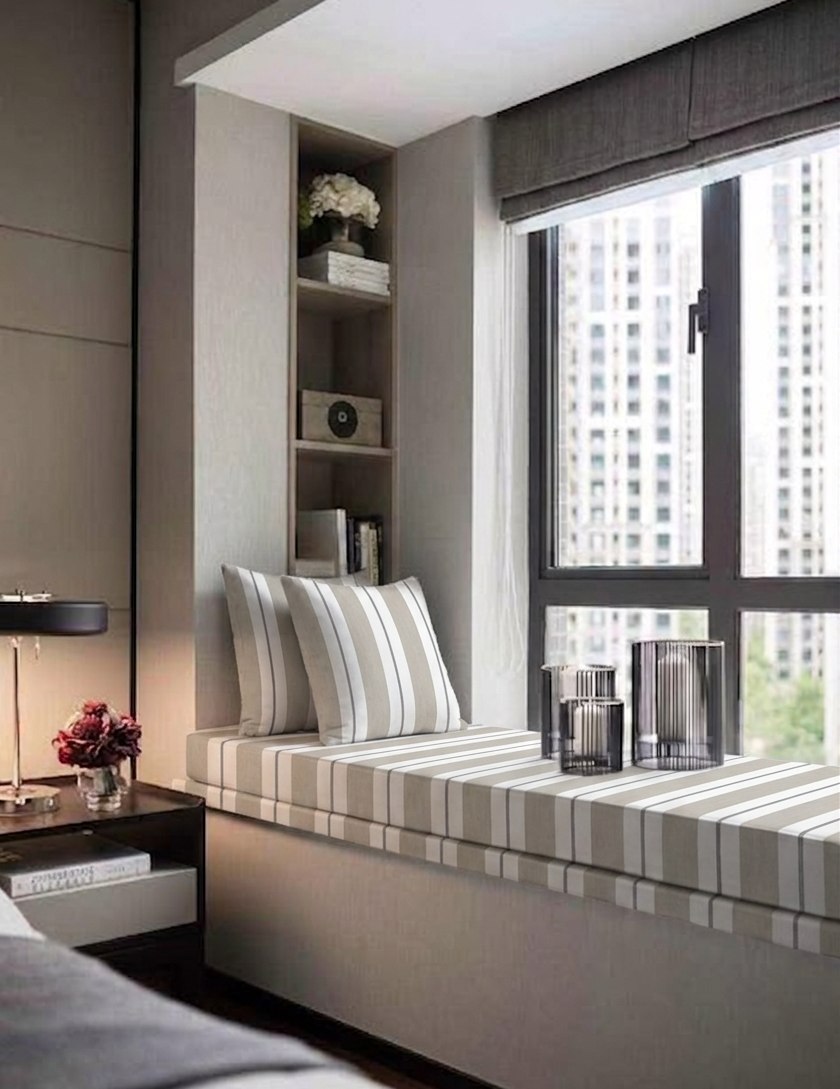 A striped bay window bench cushion in a New York apartment overlooking the city skyline